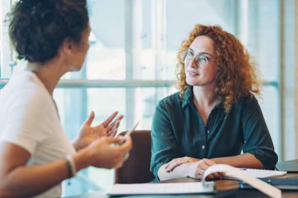 Business persons sitting around a table and talking