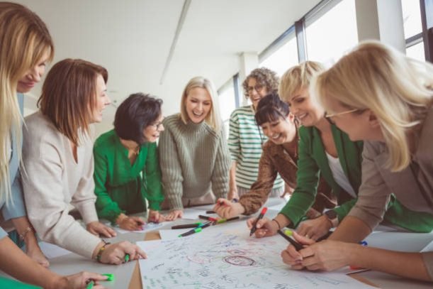 Tilt image of business colleagues doing team building activity in office