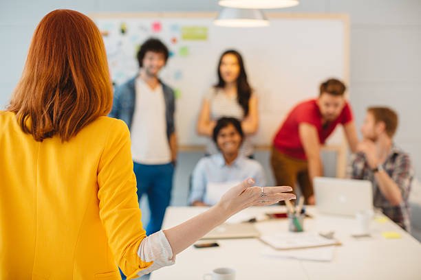 	Group of young creative people collaborating in an office. Colleague holding presentation or meeting.