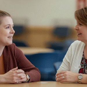 two women chatting at a table