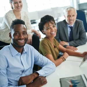 Its been a great day at the office. Portrait of a group of coworkers sitting together in an office