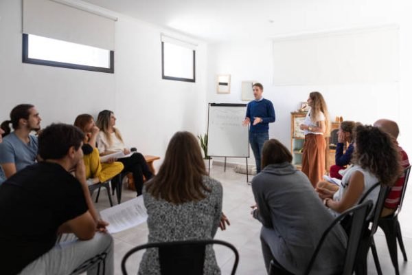 Mindfulness and yoga teachers explaining breathing techniques in a group class - Buenos Aires - Argentina